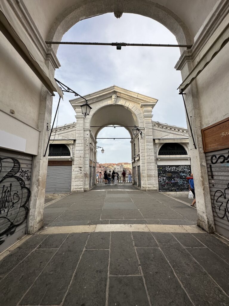Archway at the top of the Rialto bridge in Venice