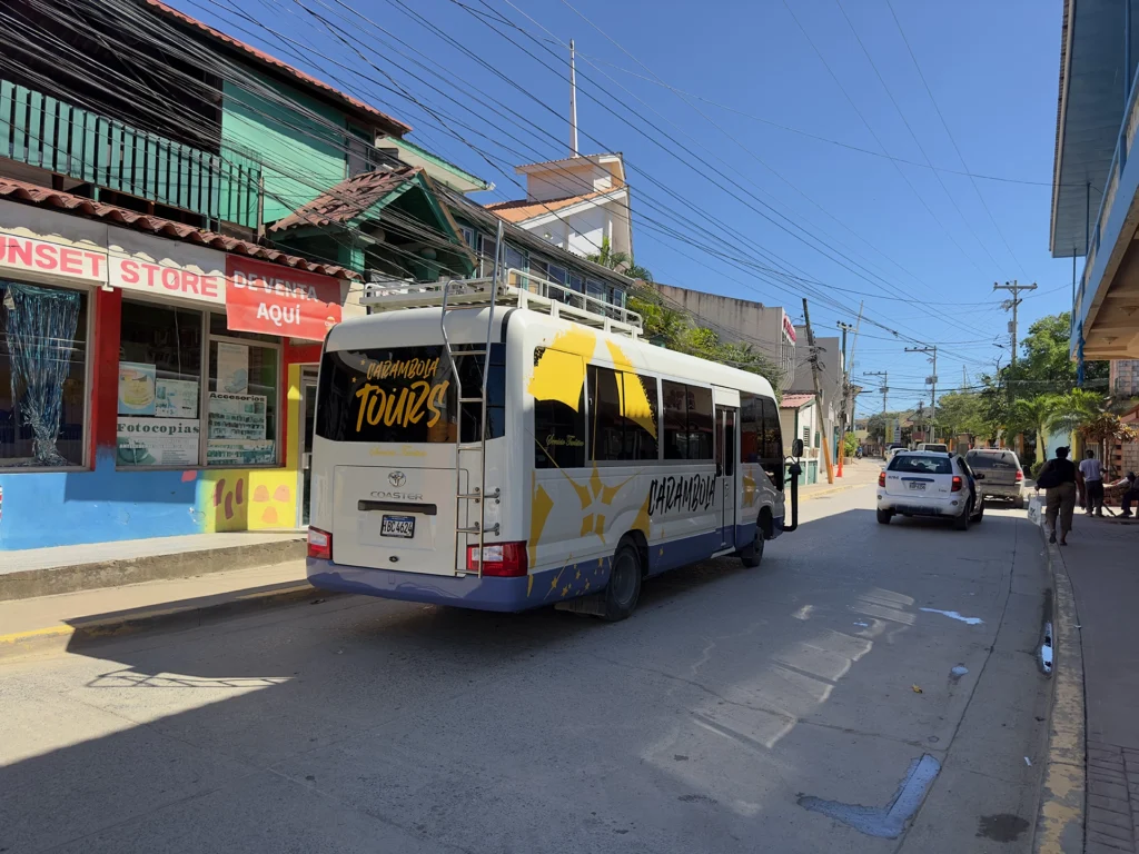 A tour bus driving through downtown  Coxen Hole, Honduras