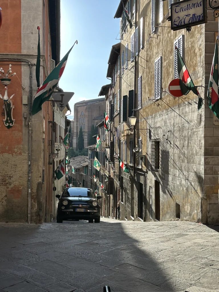 The streets in Siena are narrow. they fall off on either site of the main streets on the crest of the hill in the old quarter 