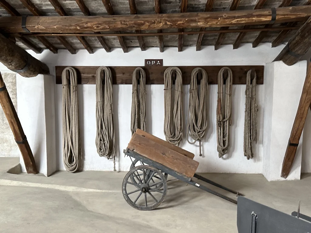 Assortment of ancient ropes and a cart used to transport materials. 