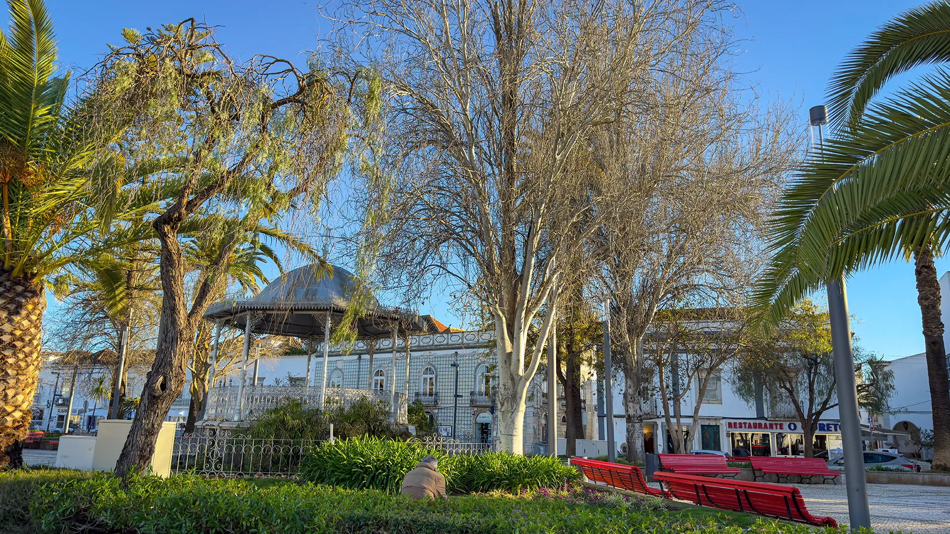 Public park in Tavira with benches, trees, and winter sunshine in the Algarve