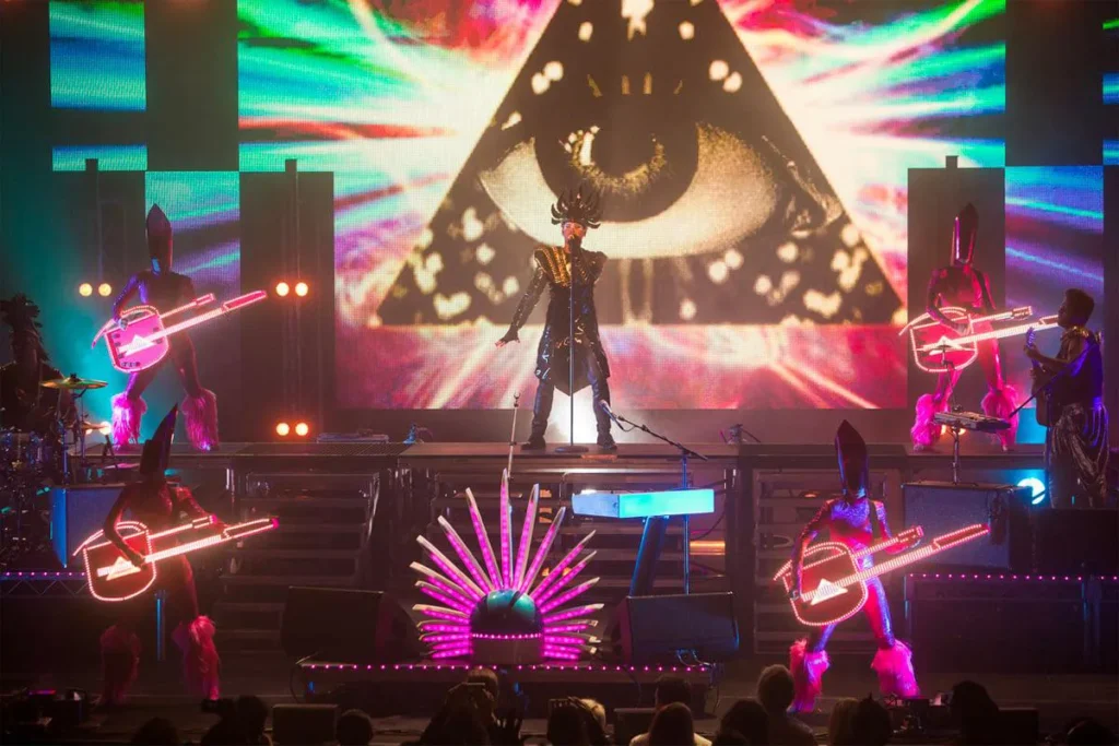 Empire of the Sun performing live on stage with colorful visuals at Feria San Marcos in Aguascalientes