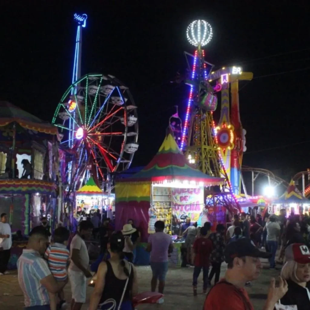 Carnival rides and Ferris wheel at night at Isla San Marcos during Feria San Marcos in Aguascalientes Mexico