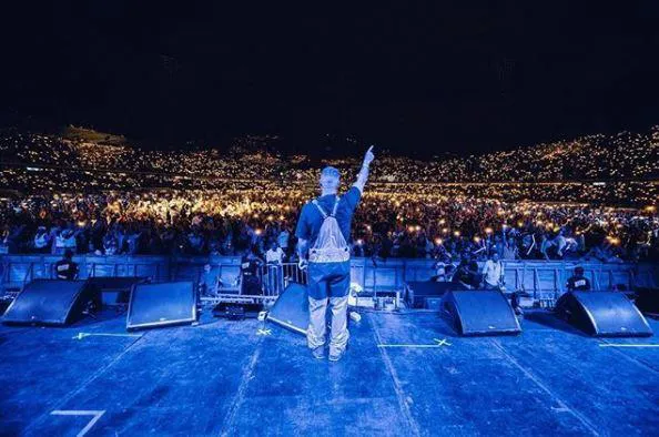 View from stage of J Balvin concert crowd at night during Feria San Marcos in Aguascalientes Mexico