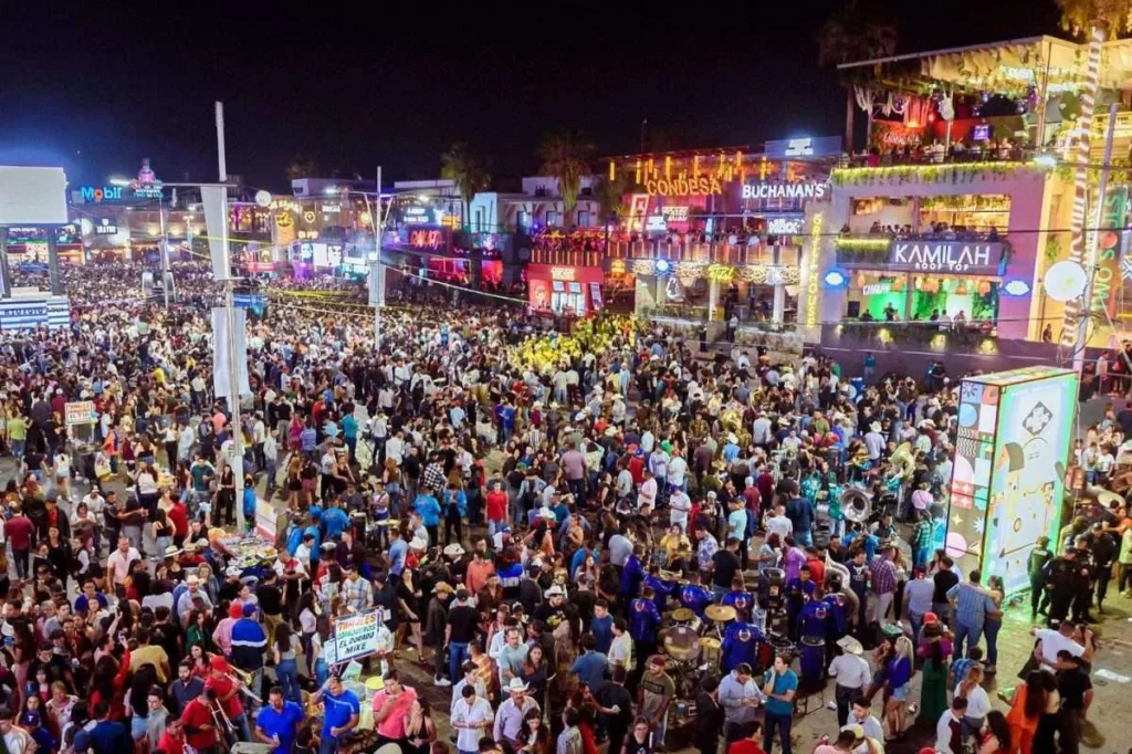 Busy nightlife scene with bars and crowd during Feria San Marcos in downtown Aguascalientes Mexico