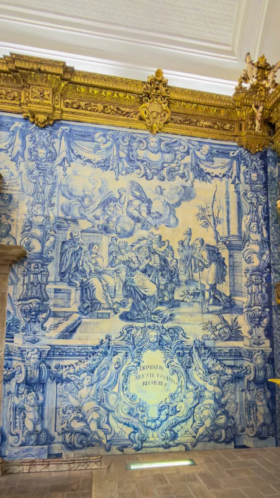 Large blue-and-white azulejo panel depicting a religious scene inside Ermida de Nossa Senhora da Conceição in Loulé, Portugal.
