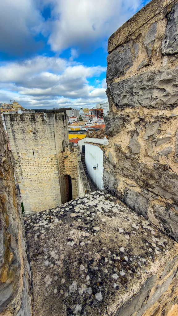 Medieval stone tower and castle walls seen from the ramparts at Loulé Castle.