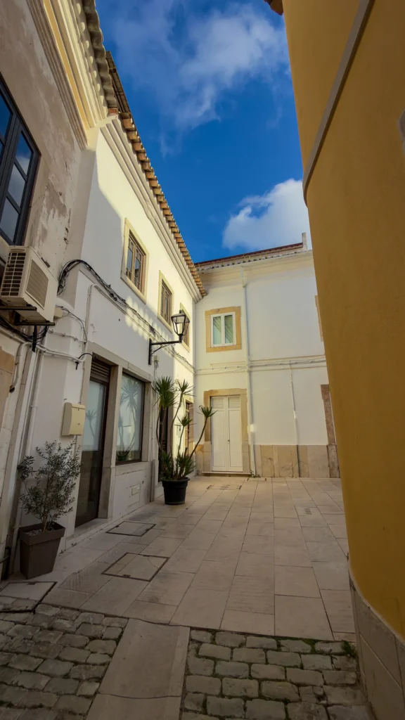 Historic pedestrian lane lined with white buildings in Loulé, Portugal.